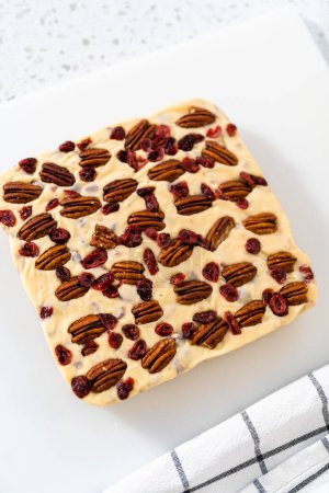 Photo for Scoring white chocolate cranberry pecan fudge for cutting into small pieces. - Royalty Free Image