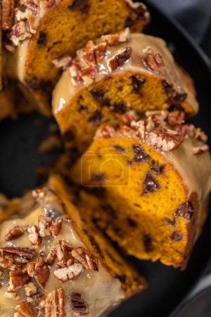 Photo for Slicing homemade chocolate pumpkin bundt cake with toffee glaze. - Royalty Free Image