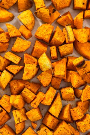 Photo for Flat lay. Cooling roasted sweet potatoes on a kitchen counter. - Royalty Free Image