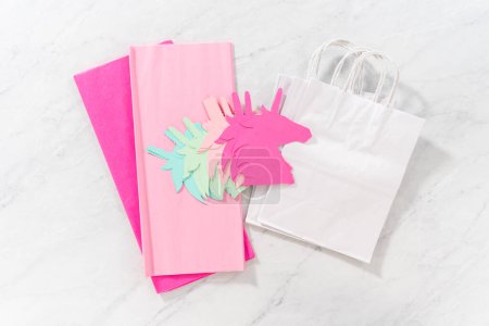 Photo for Flat lay. Materials to make unicorn Birthday party favor bags for a little girls Birthday party. - Royalty Free Image