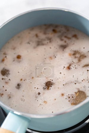 Photo for Cooking boba pearls in a cooking pot to prepare mango boba smoothie. - Royalty Free Image