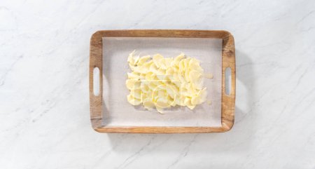 Photo for Flat lay. Spreading unsalted butter at room temperature to prepare a vegetarian party butter board for a party. - Royalty Free Image
