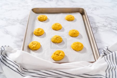Photo for Lemon Cookies with White Chocolate. Cooling freshly baked lemon cookies with white chocolate on a kitchen counter. - Royalty Free Image