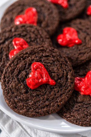 Foto de Freshly baked chocolate cookies with chocolate hearts for Valentines Day. - Imagen libre de derechos
