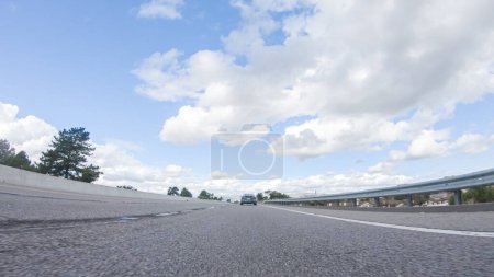 Photo for On a clear winter day, a car smoothly travels along Highway 101 near Santa Maria, California, under a brilliant blue sky, surrounded by a blend of greenery and golden hues. - Royalty Free Image