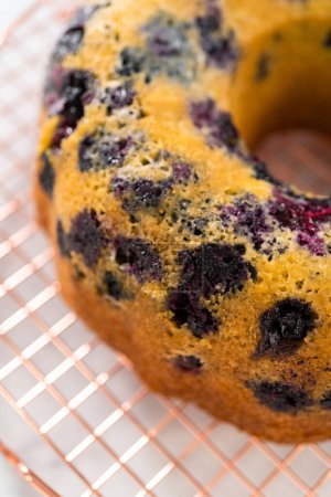 Photo for Cooling freshly baked lemon blueberry bundt cake on the kitchen counter. - Royalty Free Image