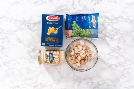 Photo for Denver, Colorado, USA-October 4, 2021 - Flat lay. Measured ingredients in a glass mixing bowl to prepare Chicken alfredo pasta. - Royalty Free Image