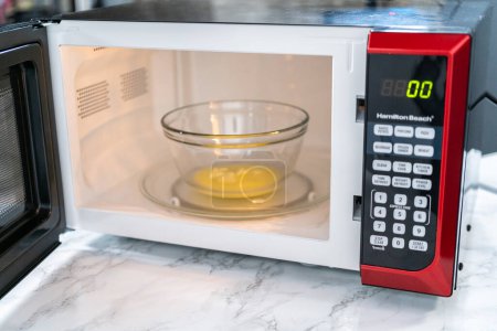 Photo for Melting stick of unsalted butter in a microwave. - Royalty Free Image