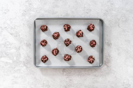 Photo for Flat lay. Scooping chocolate cookie dough with dough scoop to bake chocolate cookies with peppermint chips. - Royalty Free Image