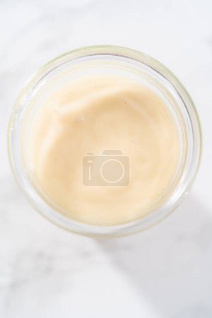 Photo for Eggnog glaze in a small glass jar. - Royalty Free Image
