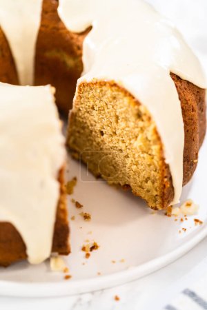 Photo for Slicing homemade eggnog bundt cake with an eggnog glaze. - Royalty Free Image