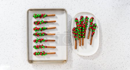 Photo for Denver, Colorado, USA-December 18, 2022-Flat lay. Removing chocolate-covered pretzels from the parchment paper. - Royalty Free Image