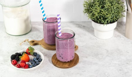 Photo for Pouring freshly made mixed berry boba smoothie into a drinking glass. - Royalty Free Image