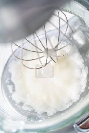 Photo for Mixing ingredients in kitchen mixer to bake Easter meringue cookies. - Royalty Free Image