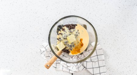 Photo for Flat lay. Melting white chocolate chips and other ingredients in the double boiler to prepare chocolate pistachio fudge. - Royalty Free Image