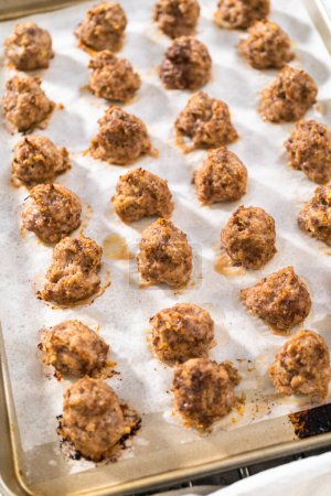 Photo for Cooling homemade oven-baked meatballs on the kitchen counter. - Royalty Free Image