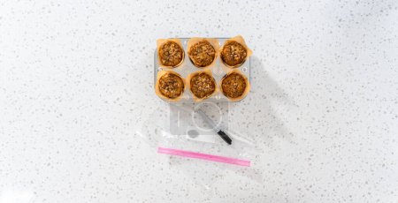Photo for Flat lay. Meal prepping. Packaging banana oatmeal muffins into the plastic back to store in a freezer. - Royalty Free Image