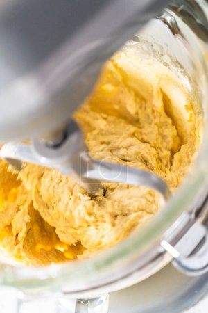 Photo for Mixing ingredients in kitchen mixer to bake mini Easter bread kulich. - Royalty Free Image