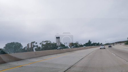 Photo for Los Angeles, California, USA-December 4, 2022-POV-Driving along Highway 101 near Rincon Beach, California, amidst a gloomy, cloudy winter day. - Royalty Free Image