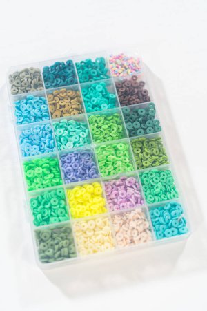 Photo for Assorted clay bead boxes neatly arranged on a white table, awaiting a creative kids craft project. - Royalty Free Image