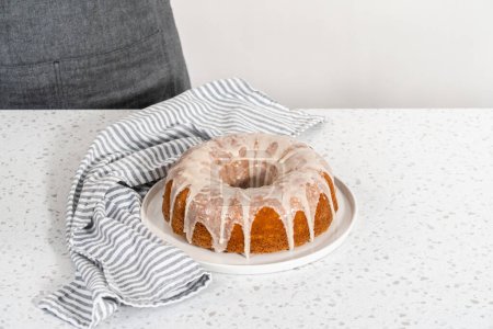 Téléchargez les photos : Gâteau de lapin à la vanille fraîchement cuit avec une glaçure blanche sur une assiette de service. - en image libre de droit