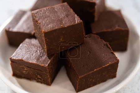 Photo for Homemade plain fudge pieces on a white ceramic plate. - Royalty Free Image