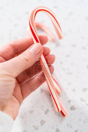 Photo for Flat lay. Peppermint candy cane on the kitchen counter. - Royalty Free Image