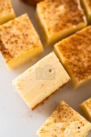 Photo for Homemade eggnog fudge pieces on a white cutting board. - Royalty Free Image