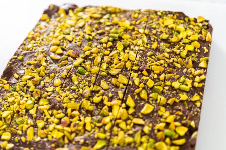Photo for Scoring chocolate pistachio fudge into perfect squares for cutting. - Royalty Free Image