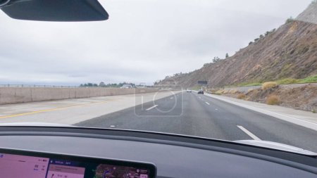 Photo for Los Angeles, California, USA-December 4, 2022-POV-Driving along Highway 101 near Rincon Beach, California, amidst a gloomy, cloudy winter day. - Royalty Free Image