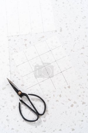 Téléchargez les photos : Préparation du gabarit de coupe à partir de papier parchemin pour couper le caramel maison. - en image libre de droit