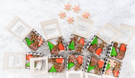 Photo for Flat lay. Packaging a homemade variety of fudge and gingerbread cookies for Christmas food gifts into paper boxes. - Royalty Free Image