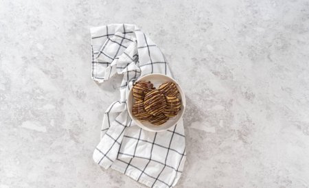 Photo for Flat lay. Freshly baked banana cookies with chocolate drizzle on a white ceramic plate. - Royalty Free Image