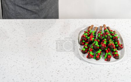 Photo for Denver, Colorado, USA-December 18, 2022-Chocolate-covered pretzels on a white serving plate. - Royalty Free Image