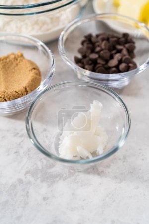Photo for Measured ingredients in glass mixing bowls to bake banana cookies with chocolate drizzle. - Royalty Free Image