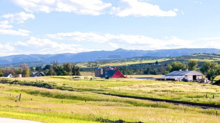 Photo for From the newly developed residential neighborhood in Colorado, a captivating view unfolds, showcasing vast farmland and a majestic mountain range in the distance, creating a picturesque and serene - Royalty Free Image