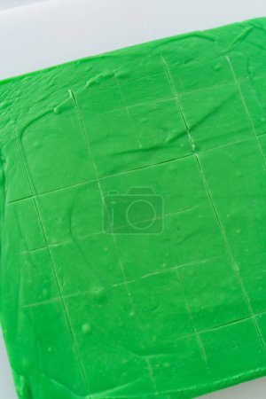 Photo for Scoring green fudge into perfect squares for cutting. - Royalty Free Image