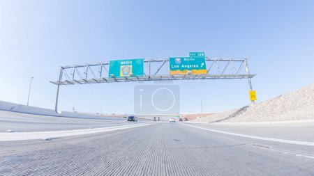 Photo for Cruising through Las Vegas in a sleek Tesla vehicle on Highway 15 during the day adds an extra touch of luxury and sustainability to your road trip adventure to California. - Royalty Free Image