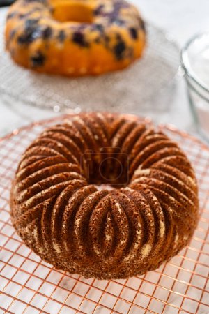 Photo for The artful extraction of the freshly baked bundt cake from its mold marks the exciting conclusion of the baking process. - Royalty Free Image