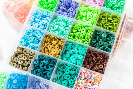 Photo for Assorted clay bead boxes neatly arranged on a white table, awaiting a creative kids craft project. - Royalty Free Image