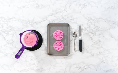 Photo for Flat lay. Preparing pink chocolate bows to decorate panda-shaped shortbread cookies. - Royalty Free Image