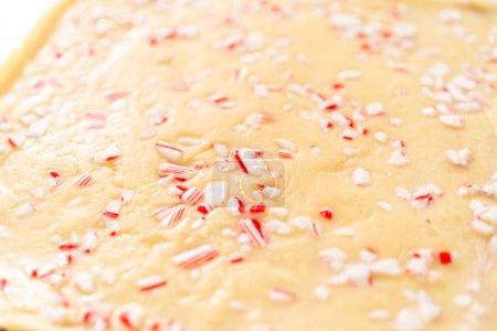 Photo for Scoring candy cane fudge into the reusable plastic bag. - Royalty Free Image
