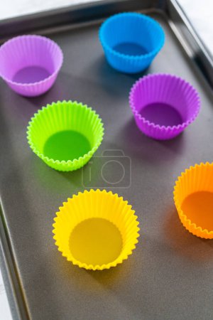 Photo for New silicone cupcake liners of different colors on the kitchen counter. - Royalty Free Image