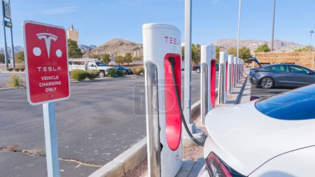 Photo for Primm, Nevada, USA-December 3, 2022-During the day, a Tesla vehicle is seen charging at a Tesla Supercharging station, utilizing the high-speed charging infrastructure for convenient and efficient - Royalty Free Image