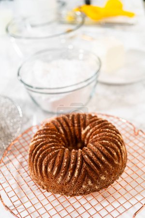 Photo for The artful extraction of the freshly baked bundt cake from its mold marks the exciting conclusion of the baking process. - Royalty Free Image