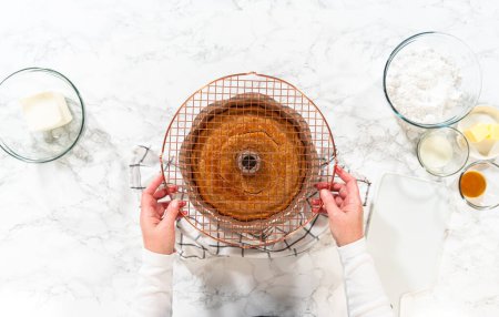 Photo for The freshly baked Carrot Bundt Cake is left to cool on the kitchen counter, filling the air with delightful aromas. - Royalty Free Image