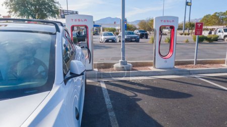 Photo for Primm, Nevada, USA-December 3, 2022-During the day, a Tesla vehicle is seen charging at a Tesla Supercharging station, utilizing the high-speed charging infrastructure for convenient and efficient - Royalty Free Image