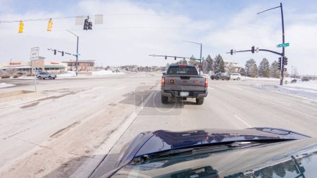 Photo for Castle Pines, Colorado, USA-January 30, 2023-Post-winter storm, the drive on a suburban road provides a peaceful journey. The picturesque scene, with snow adorning the landscape, adds to the - Royalty Free Image