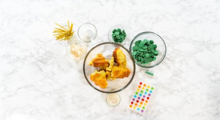 Photo for Flat lay. Measured ingredients in glass mixing bowls to make cactus cake pops for the Cinco de Mayo celebration. - Royalty Free Image