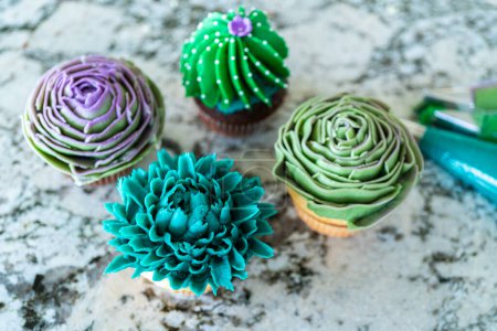 Photo for Using buttercream frosting, vanilla and chocolate cupcakes are intricately decorated to resemble various types of cactuses, creating a delightful and visually engaging dessert that showcases - Royalty Free Image